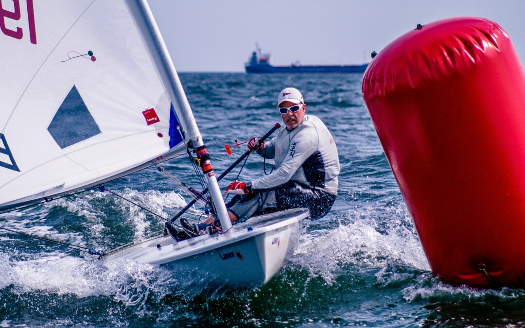 Man racing sailboat.